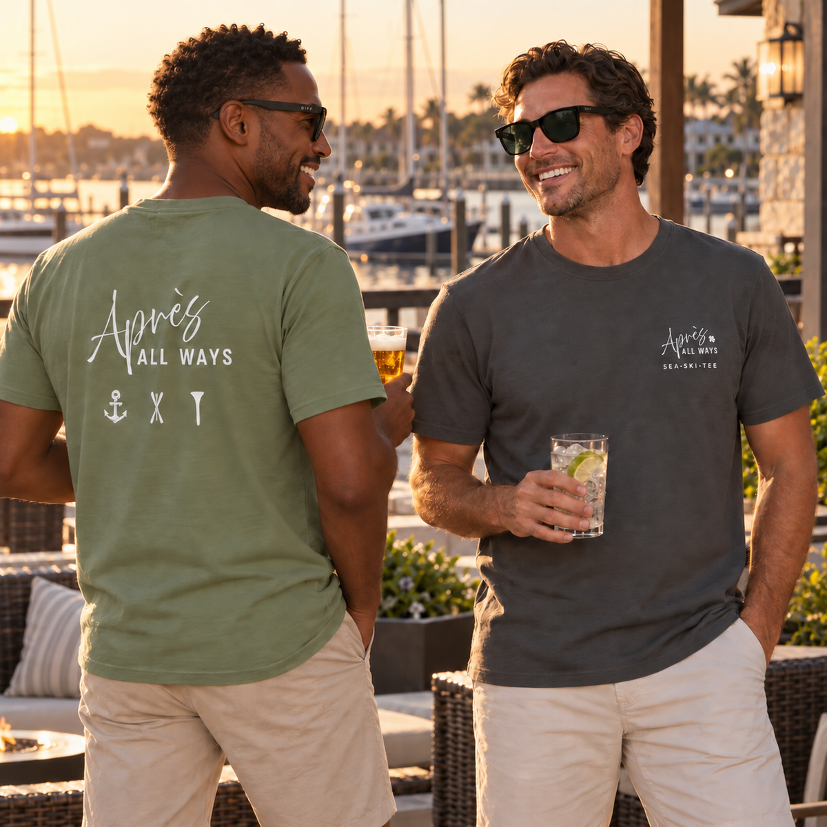 Two men wearing Après All Ways T-shirts and DIFF sunglasses while enjoying drinks beside a marina at sunset.