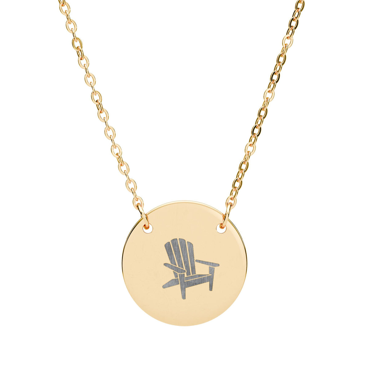 Après All Ways gold necklace with a round pendant engraved with an Adirondack chair, suspended from a delicate oval-link chain on a white background.