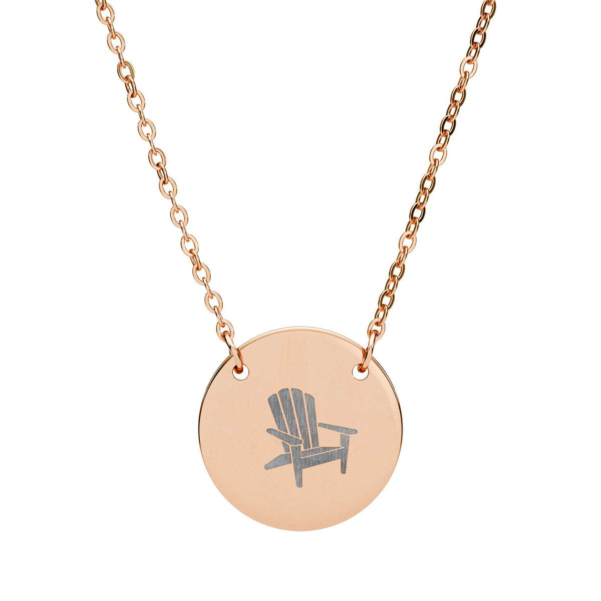Après All Ways gold necklace with a round pendant engraved with an Adirondack chair, suspended from a delicate oval-link chain on a white background.