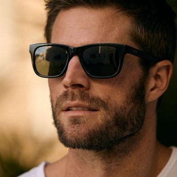 Man wearing DIFF Wesley sunglasses with a blurred natural background